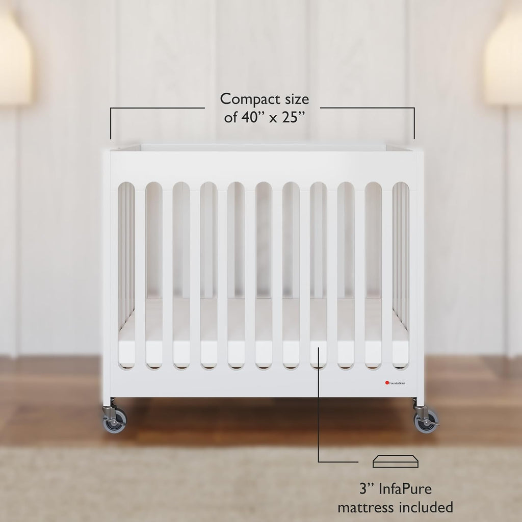 Foundations Boutique Folding Mini Baby Crib - Compact, Portable, Wooden Hotel Crib, Foldable Compact Cribs for Baby & Toddlers - Includes 3" Foam Mattress - White