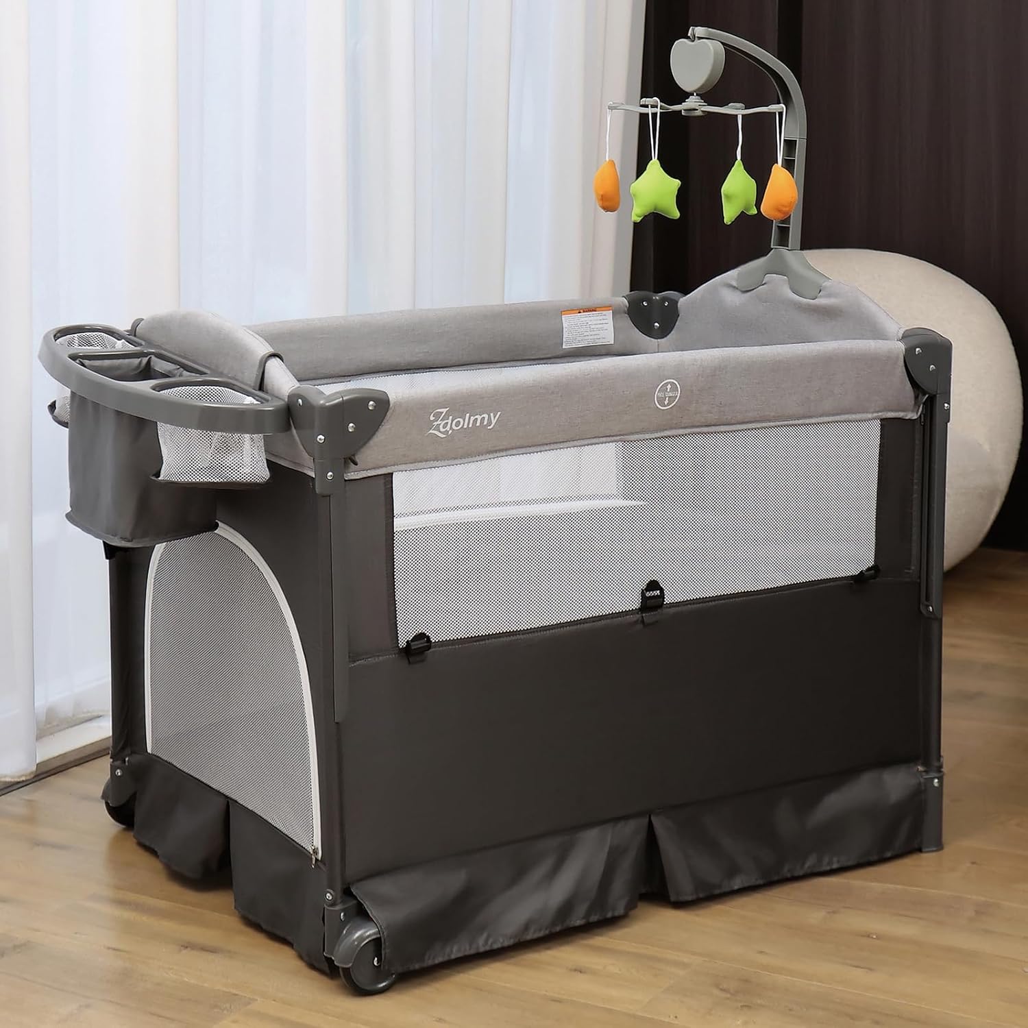 Zdolmy Baby Bedside Sleeper Bassinet, 4-in-1 Pack and Play with Bassinet w/Diaper Changing Table & Storage Bag, 3 Adjustable Heights, Toy Arch & Music, Portable Baby Play Yard with Carry Bag