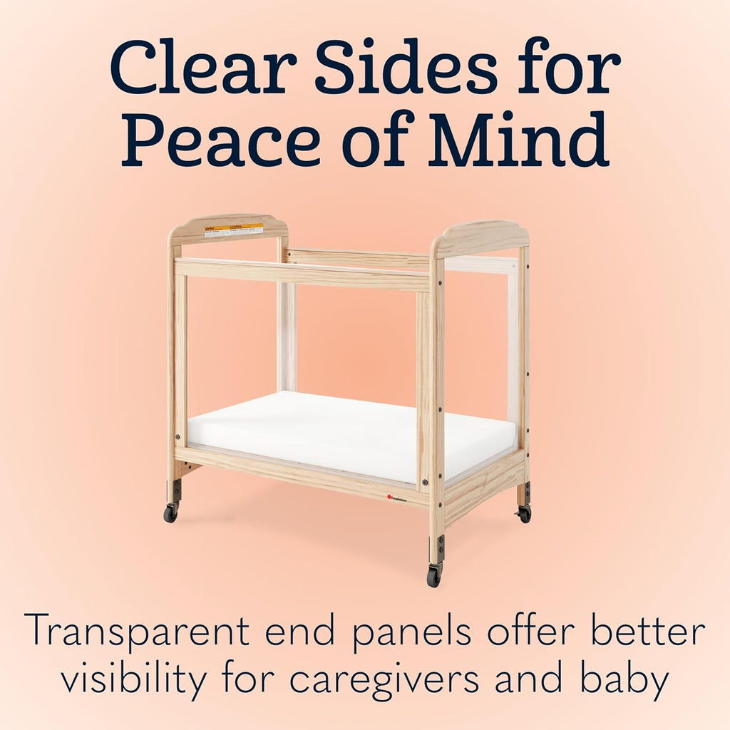 Foundations Serenity Compact Clearview Daycare Crib, Fixed Side, Durable Wood Construction, Non-Marking Casters (2 Locking), Includes 3” InfaPure Foam Mattress (Natural)